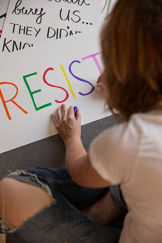 Woman making protest signs.