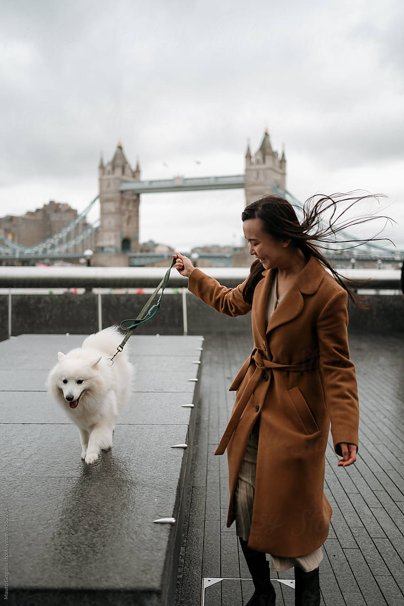 Woman walks outdoor with her dog in London