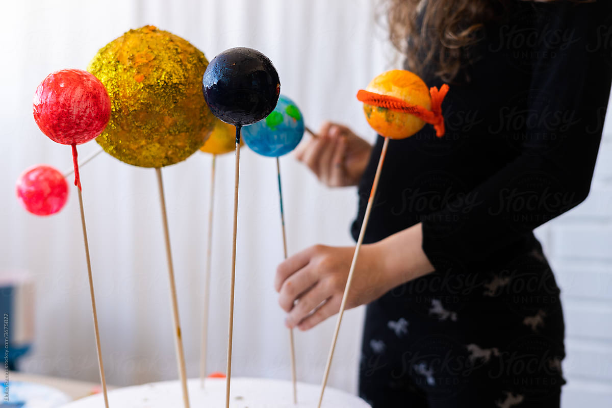 Close-up of young girl doing a handmade Solar System Craft For Science