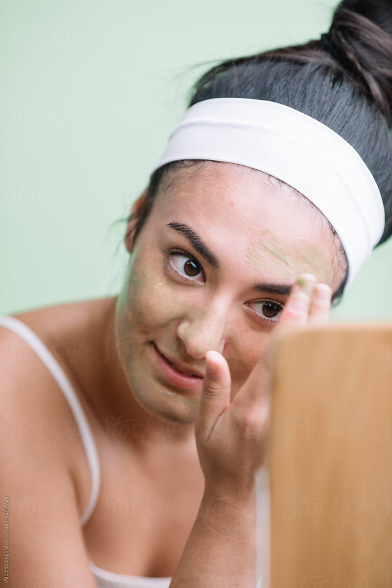 Young Japanese Girl Applying Face Mask