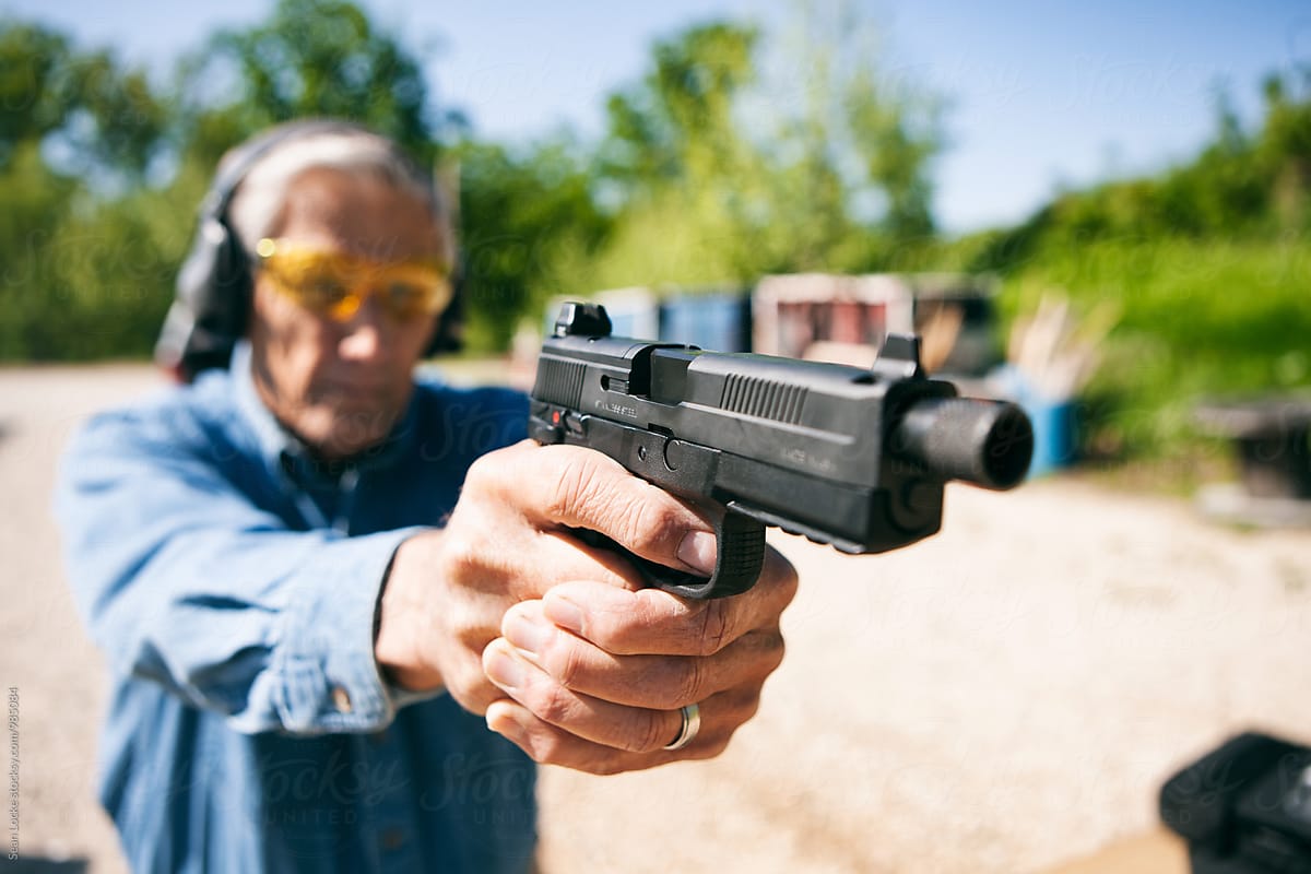 Shooting: Senior Male Aims Handgun At Target