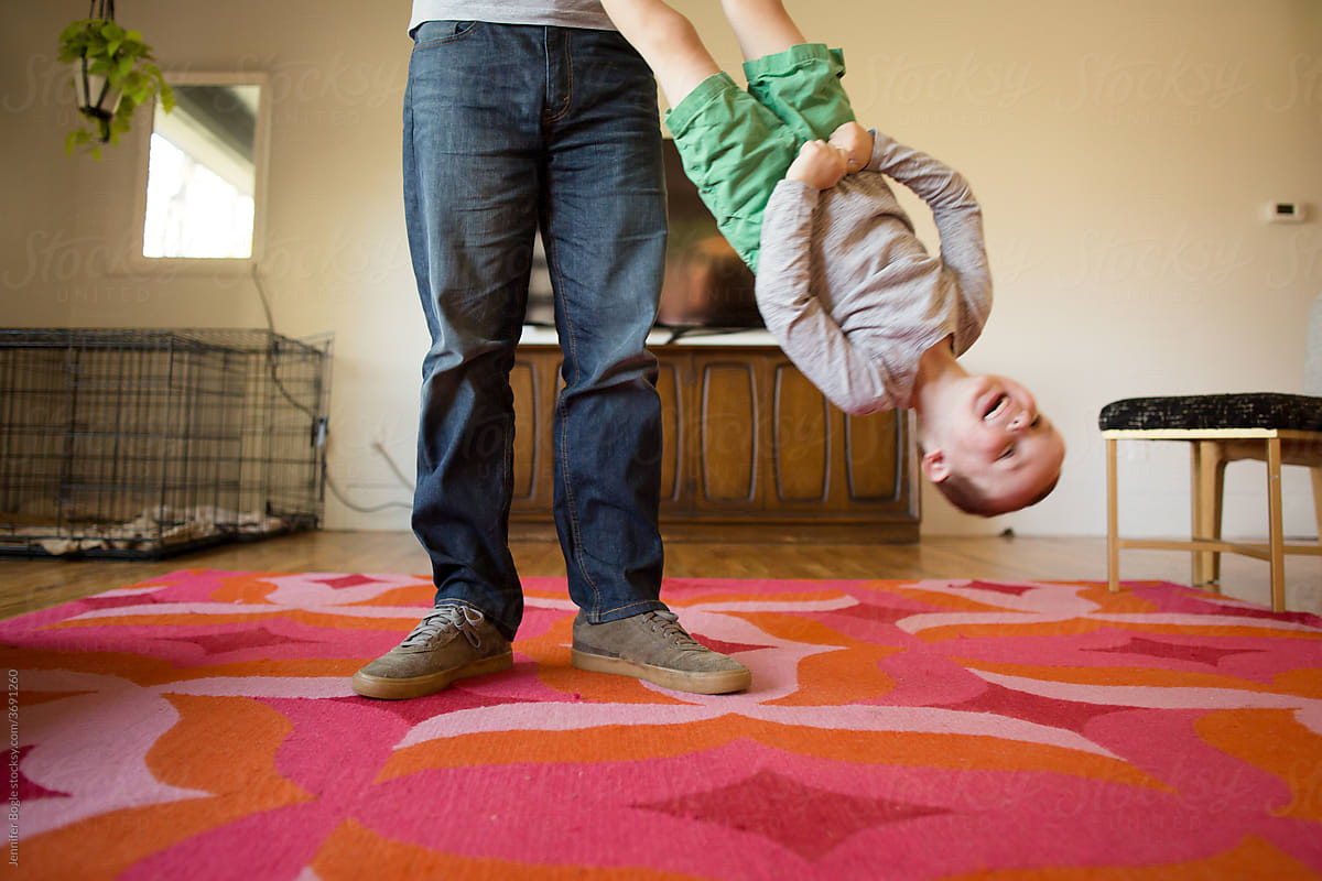 Father swings son upside down