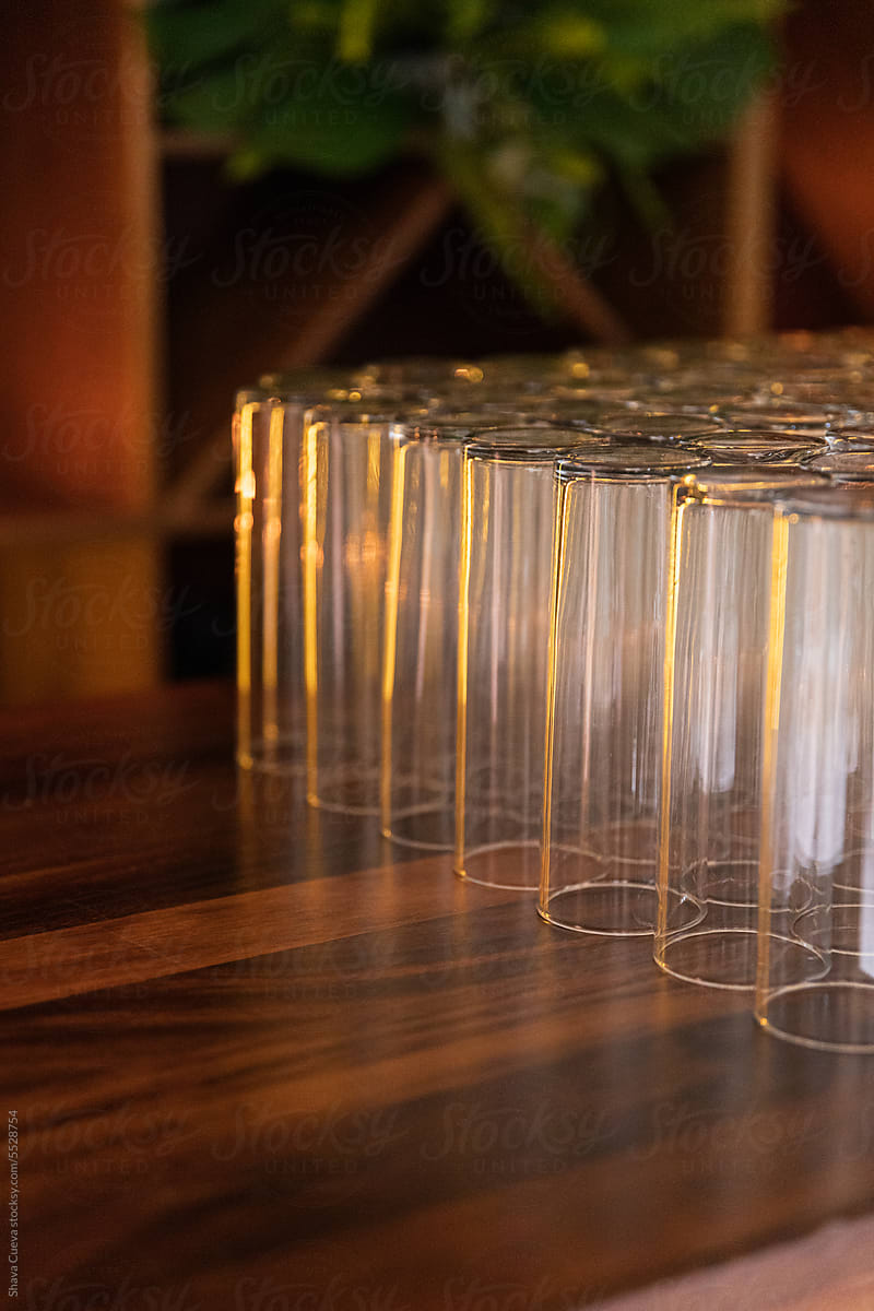 Tall glasses placed in a diagonal line on bar counter