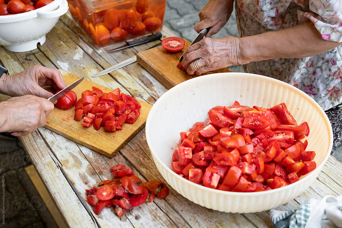 Cleaning and cutting tomatoes for making handmade sauce
