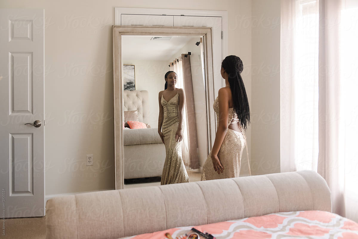 Teen With Prom Dress Looking At Herself In Mirror by Stocksy Contributor Léa Jones Stocksy
