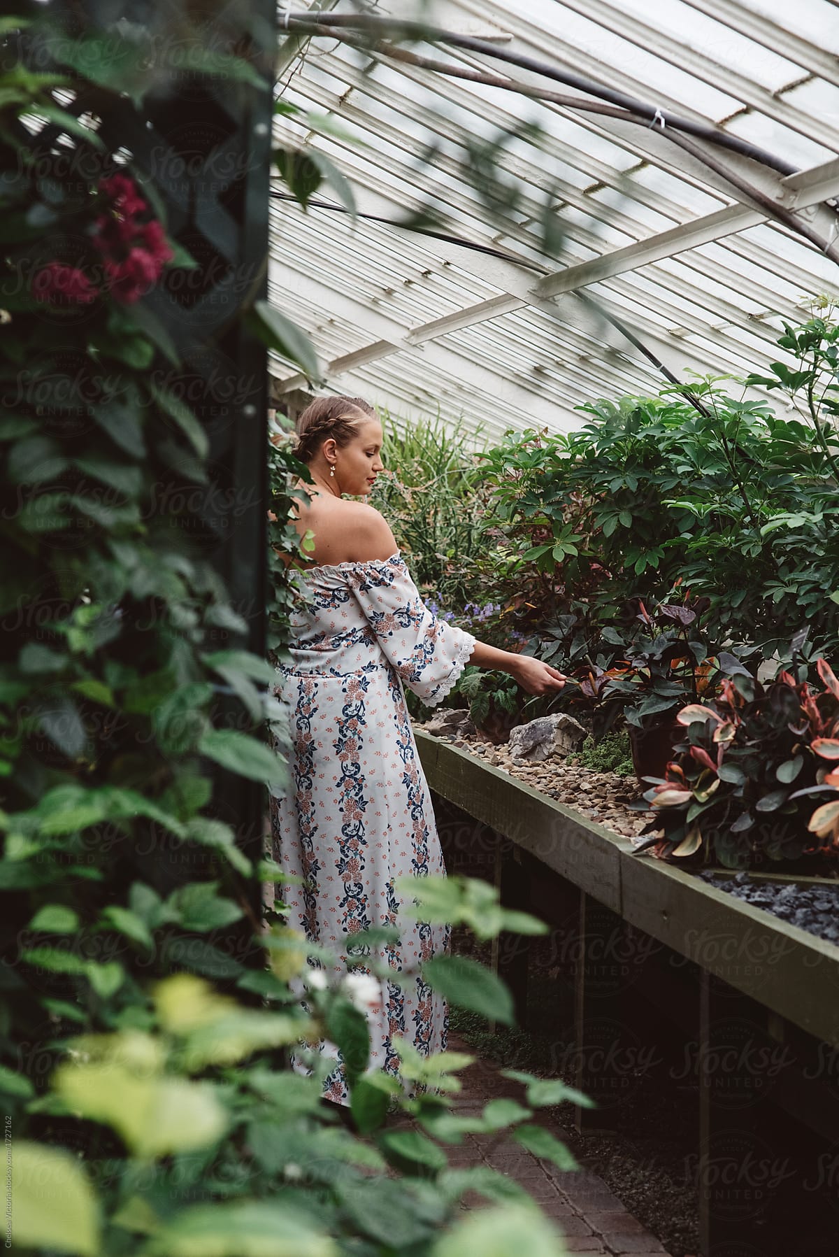 A Woman In Her Twenties In A Botanical Greenhouse By Stocksy 
