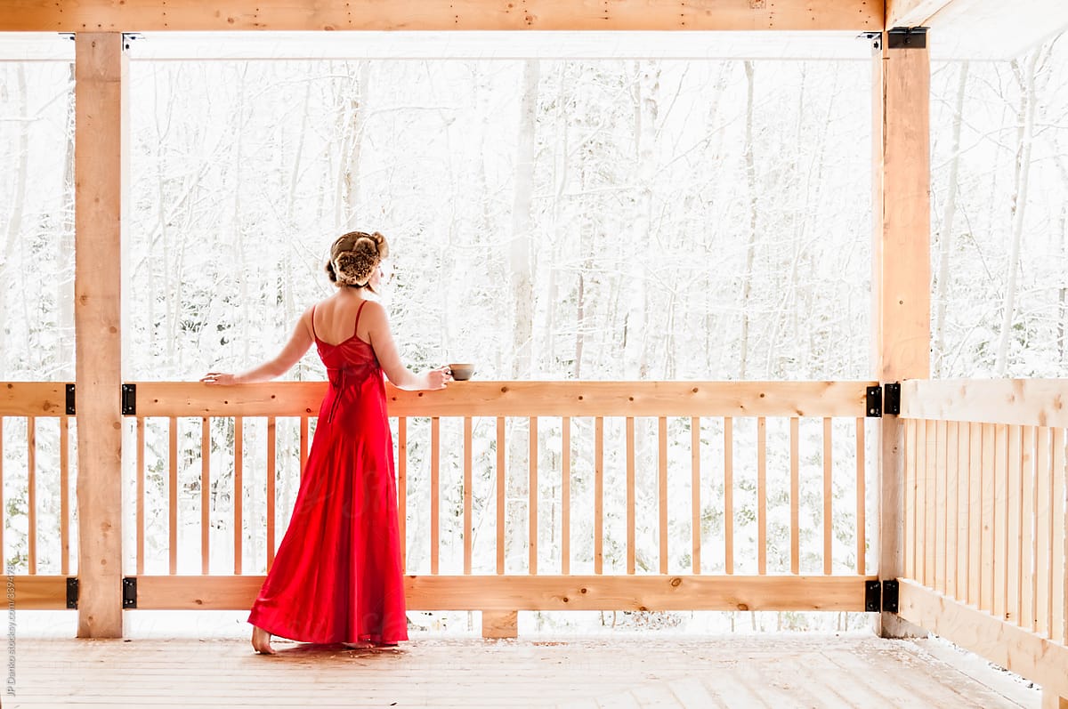 Woman In Red Nightgown Lingerie On Snowy Winter Morning At Cabin