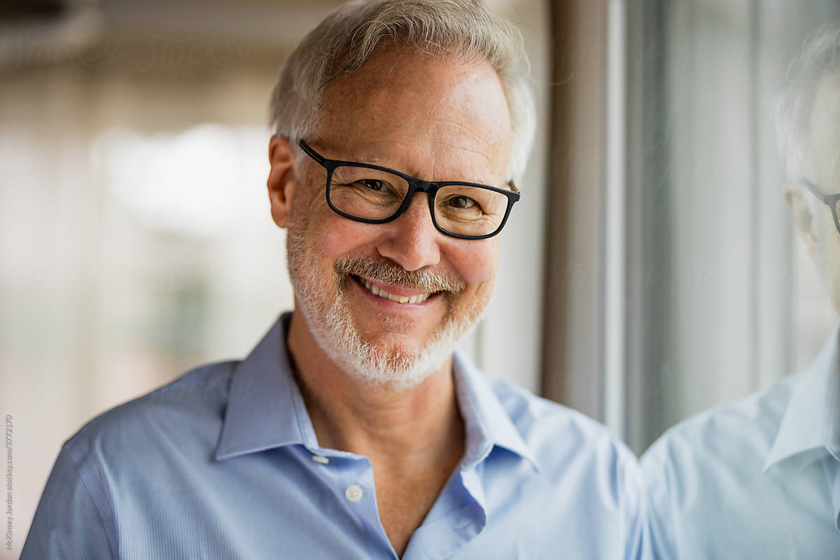 Man Wearing Glasses Smiles into Camera