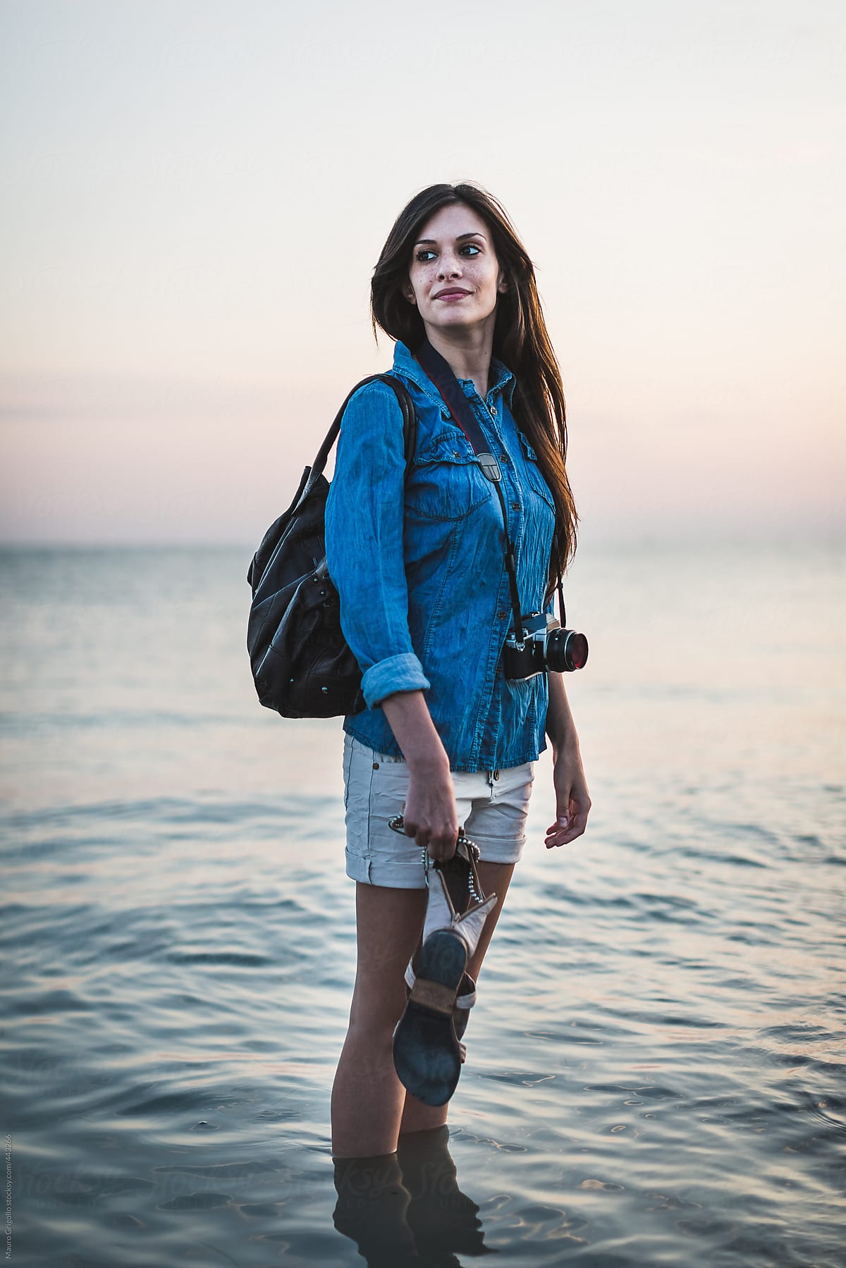 Female photographer walking on the beach