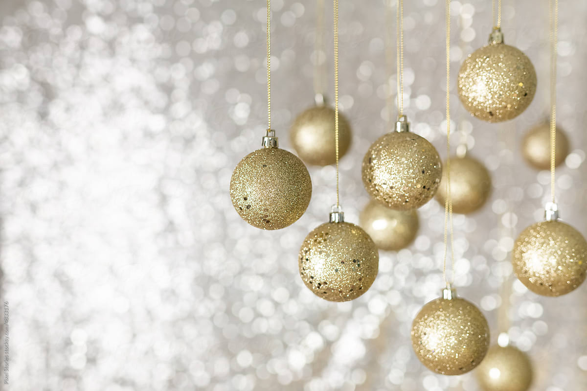 Golden Christmas baubles against shiny background