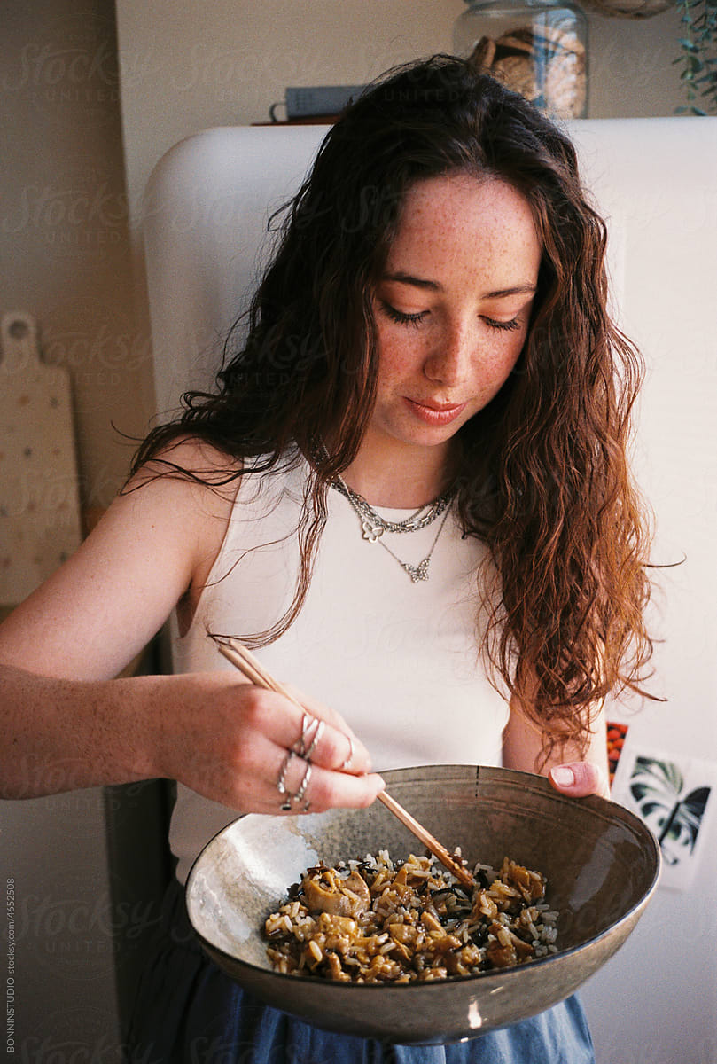 User-generated content freckled teen girl eating in kitchen
