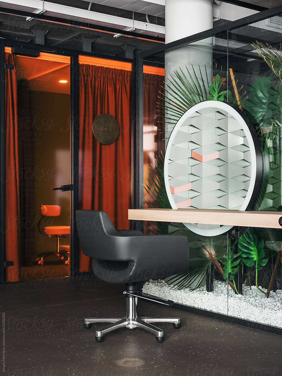 Table with armchair and mirror in hairdressing salon