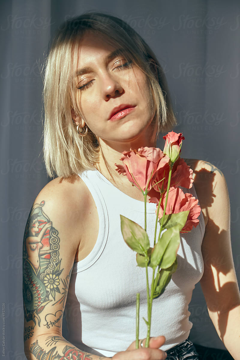 PORTRAIT OF A GIRL WITH FLOWERS OVER A WHITE BACKGROUND