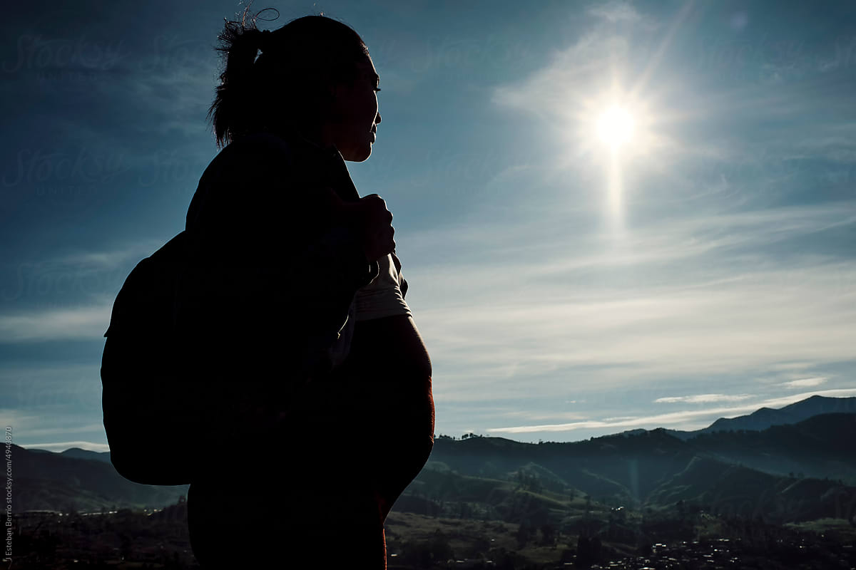 Silhouette of pregnant woman hiking