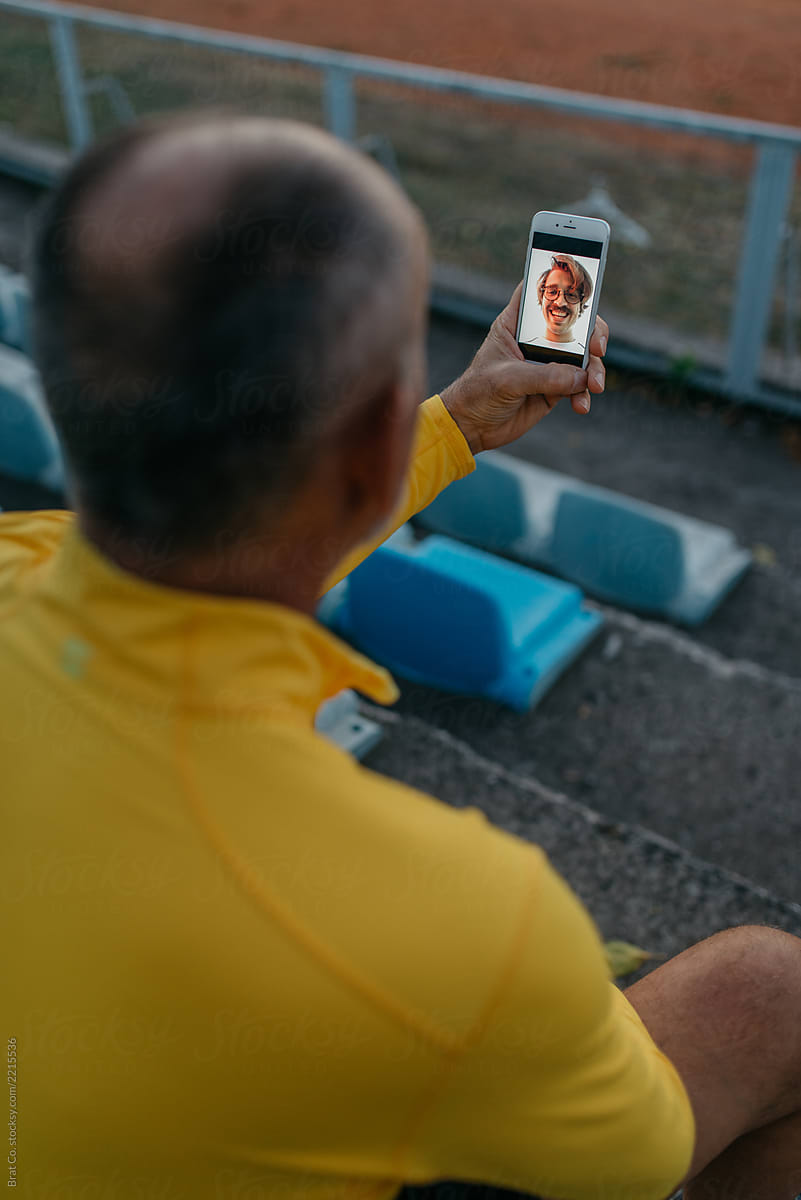 Senior sportsman using video chat