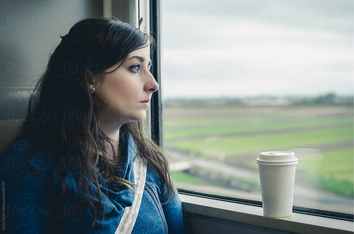 Woman With Coffee Cup Riding A Train