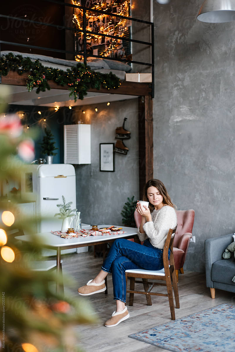 Young woman enjoying hot beverage on Christmas Day