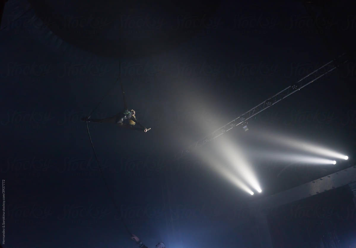 Flying Graceful Acrobat In Circus Lights
