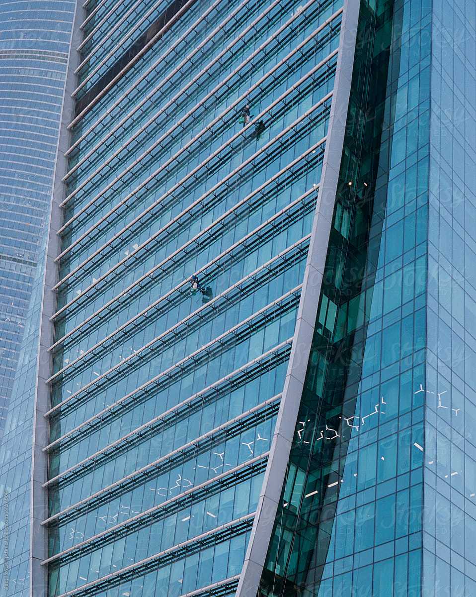View of a skyscraper with window cleaners
