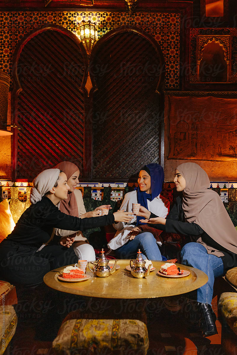 Group Of Diverse Muslim Friends Sitting At Tea House Table By Stocksy Contributor Victor 4637