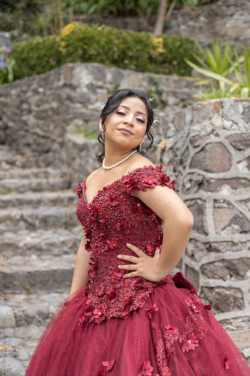 A Mexican Quinceanera Posing Looking At The Camera" by Stocksy Contributor  "Moy Ortega" - Stocksy