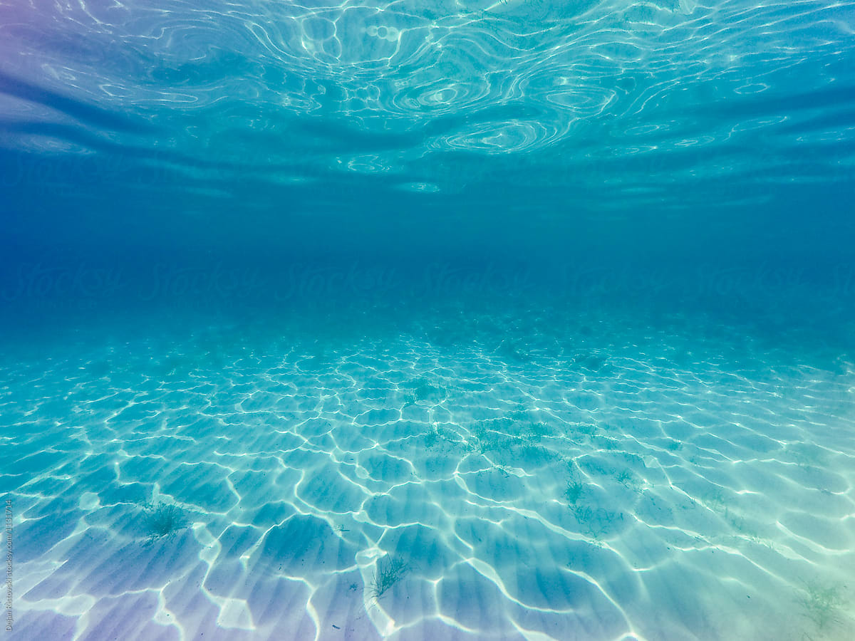 Sunray Ripples Underwater In Clear Blue Sea Water. by Dejan Ristovski