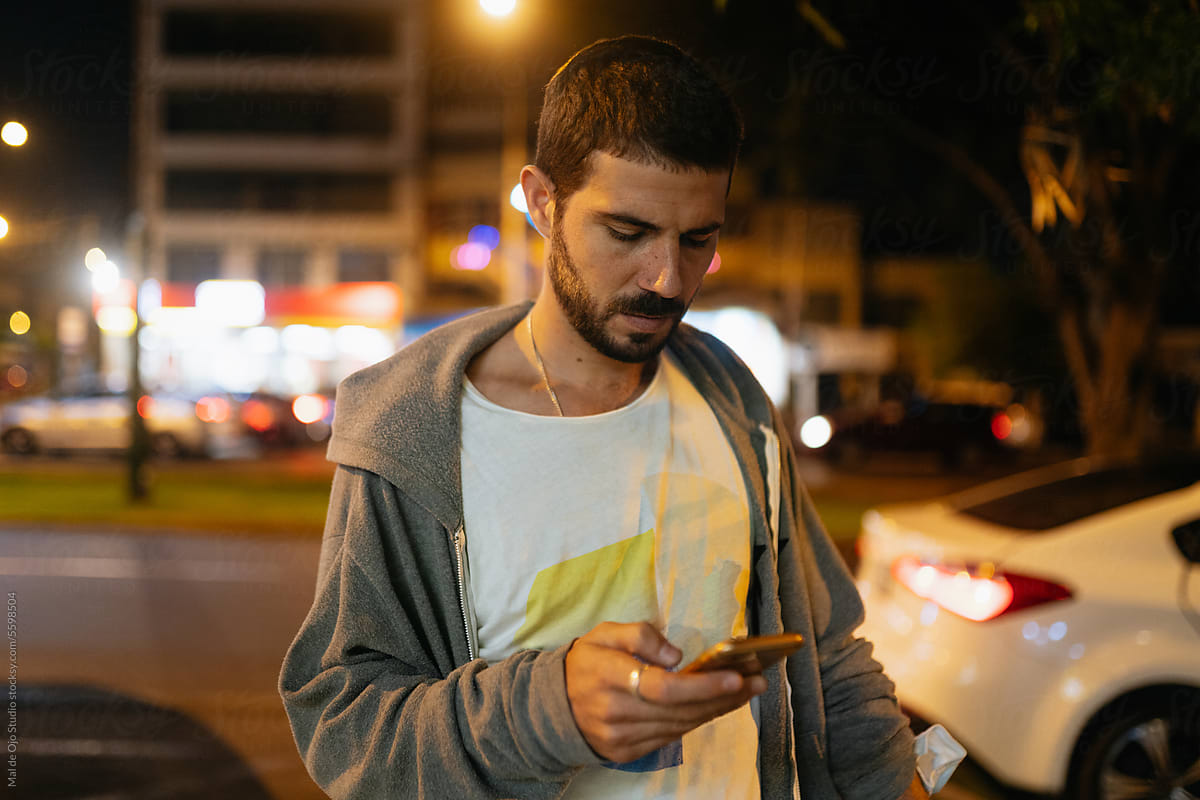 Man checking phone in the street