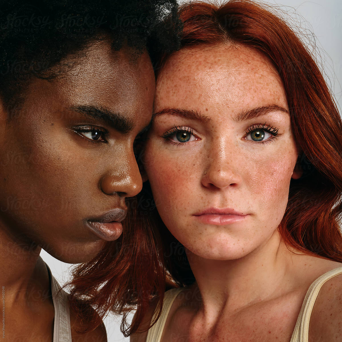 Close-up portrait of Black woman and redhead with freckles