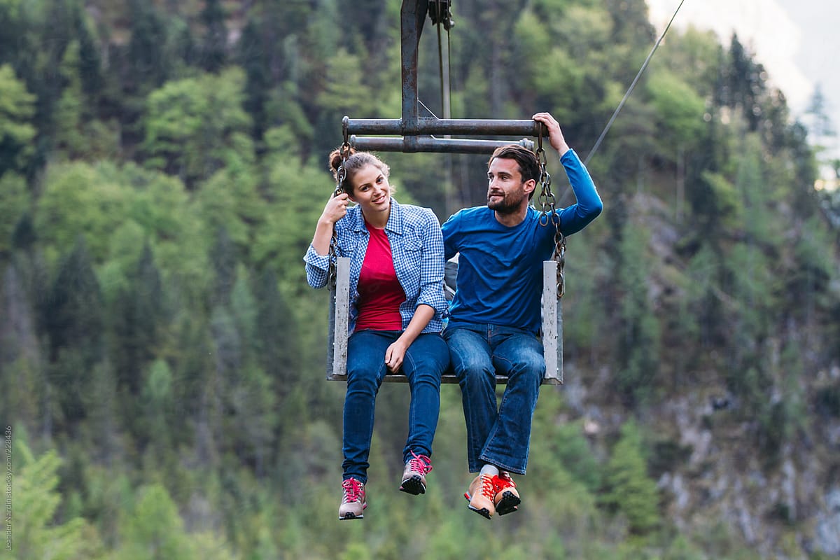 young enamored couple in a goods cable lift