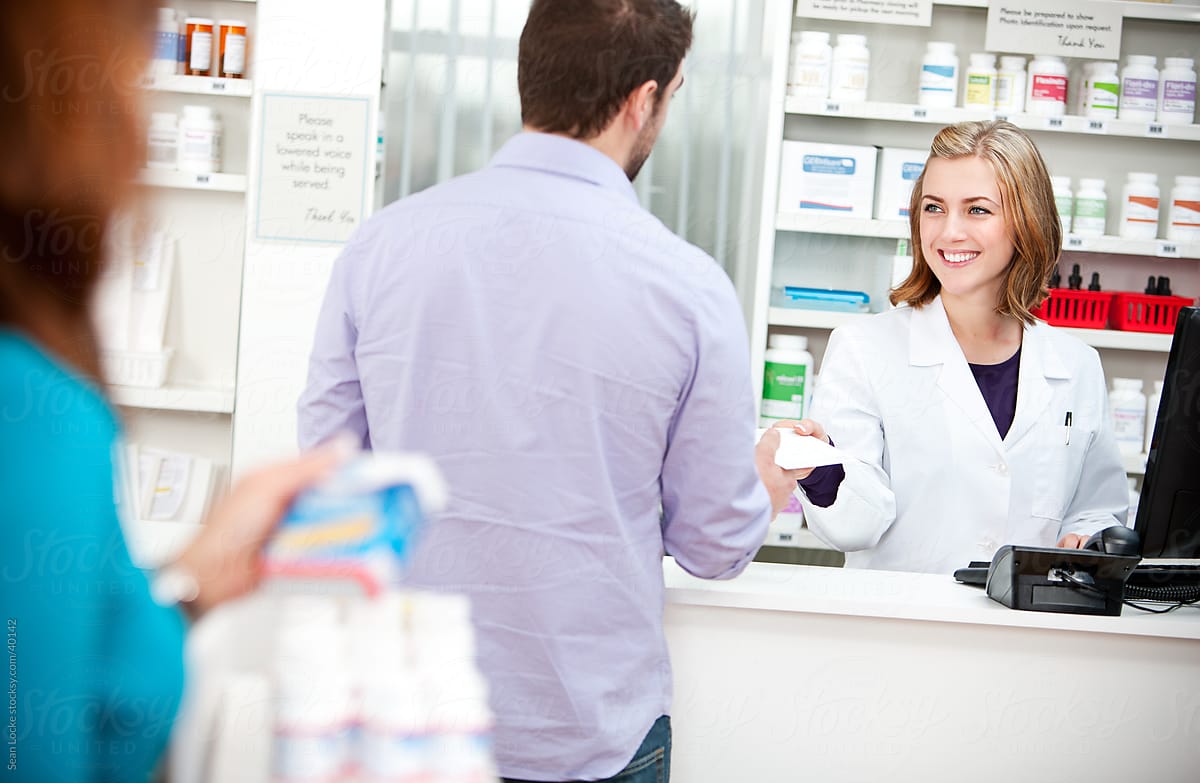 Pharmacy: Customer Hands Prescription to Pharmacist