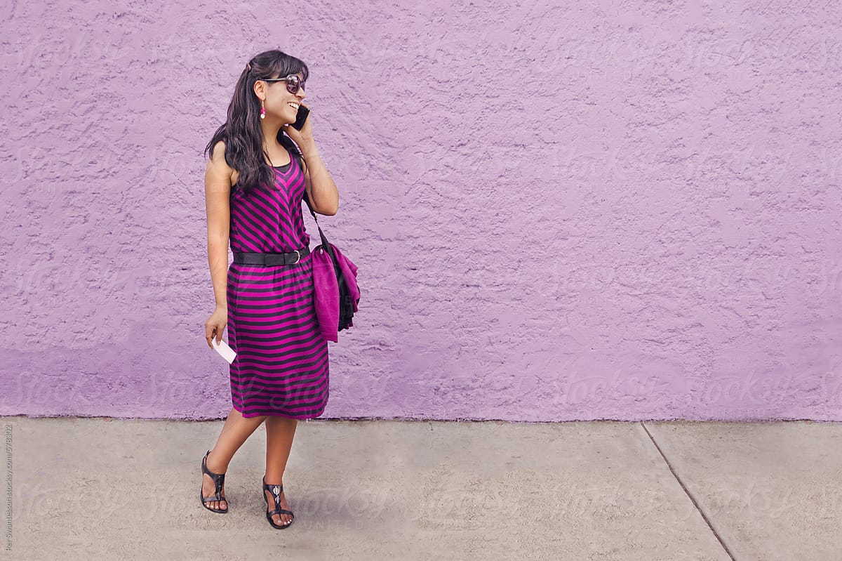 Purple dress woman at purple wall