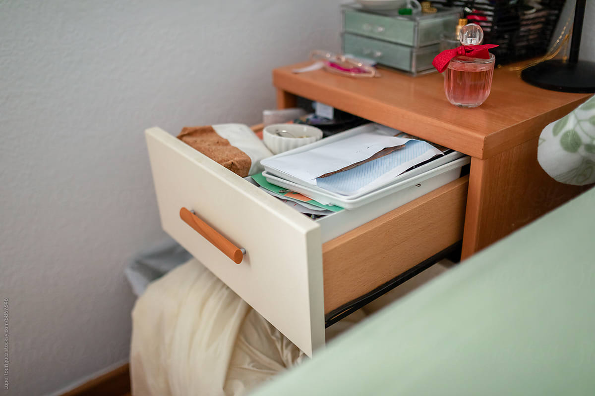 nightstand drawer open and full of things