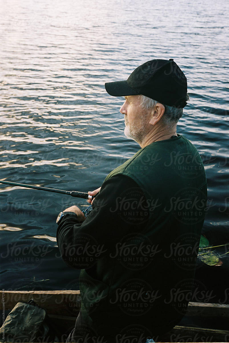 Film photo of a man fishing on a lake