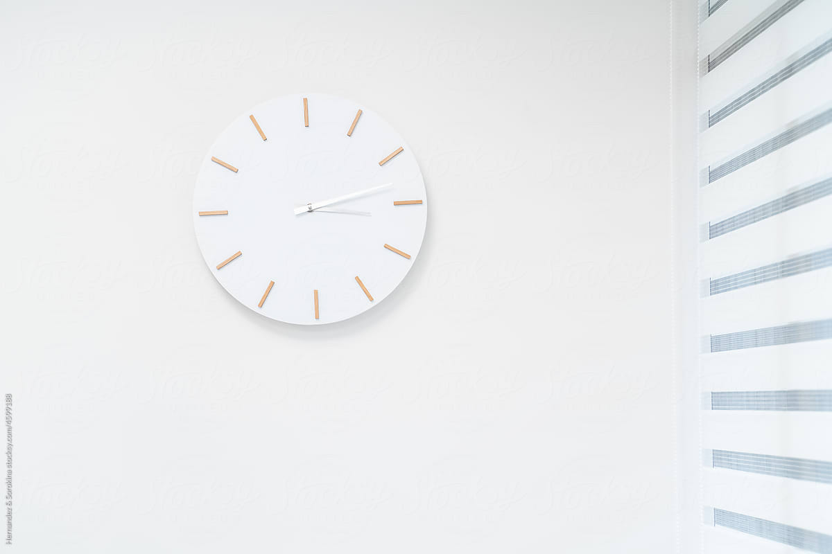 White Clock In White Wall Background