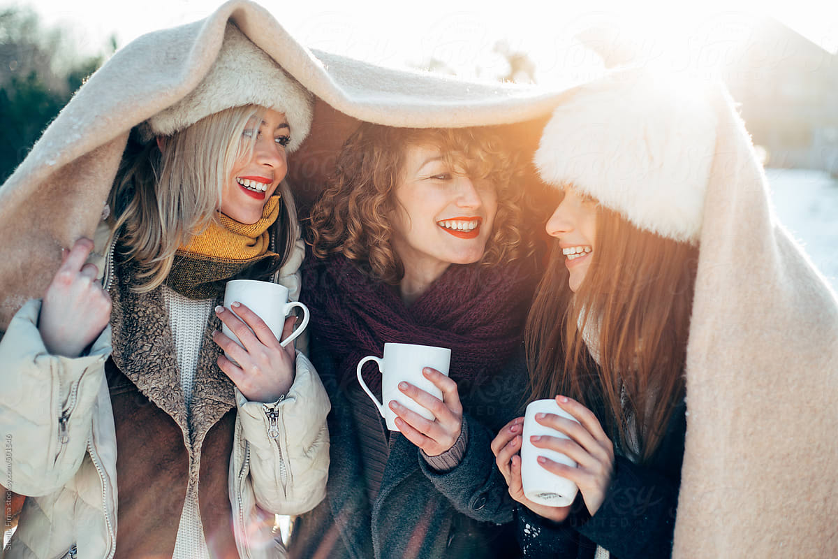 Girls drinking coffee outside.
