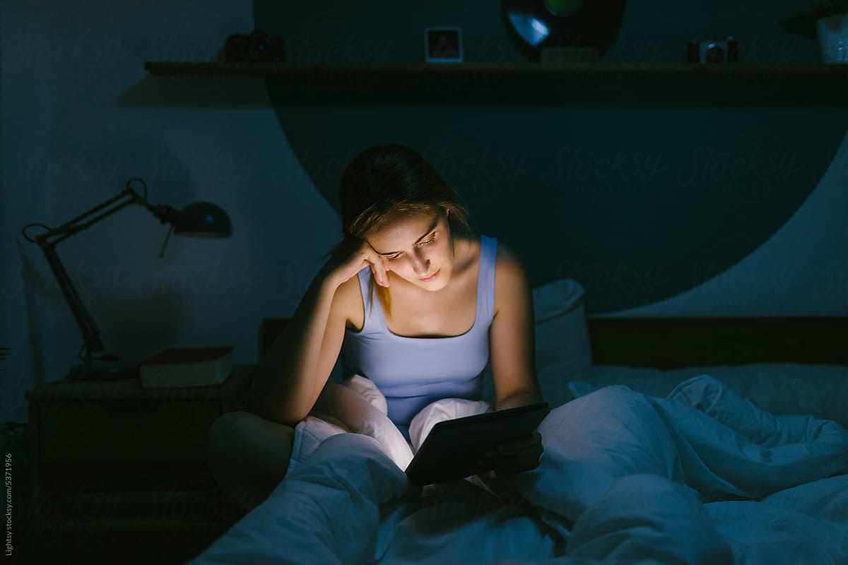 Woman studying in her bed