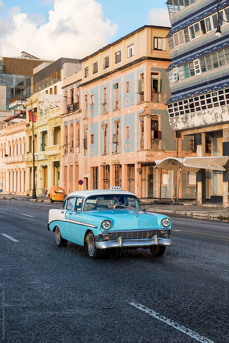 Classic car passing at top speed in El Malecon, Cuba
