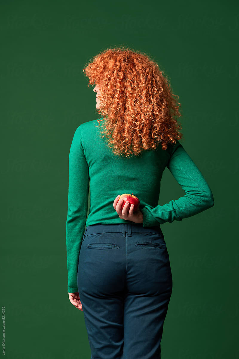 Curly redhead lady with apple
