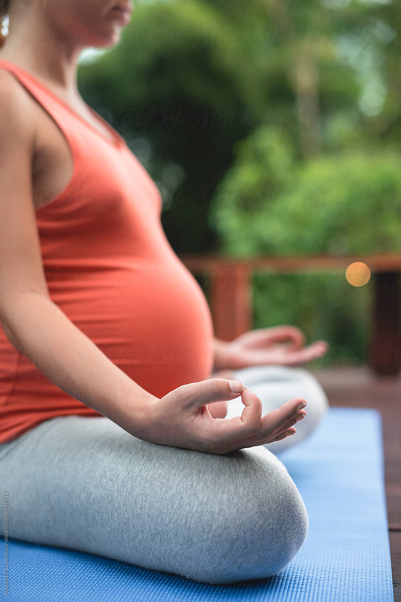 Pregnant Woman Meditate In A Garden