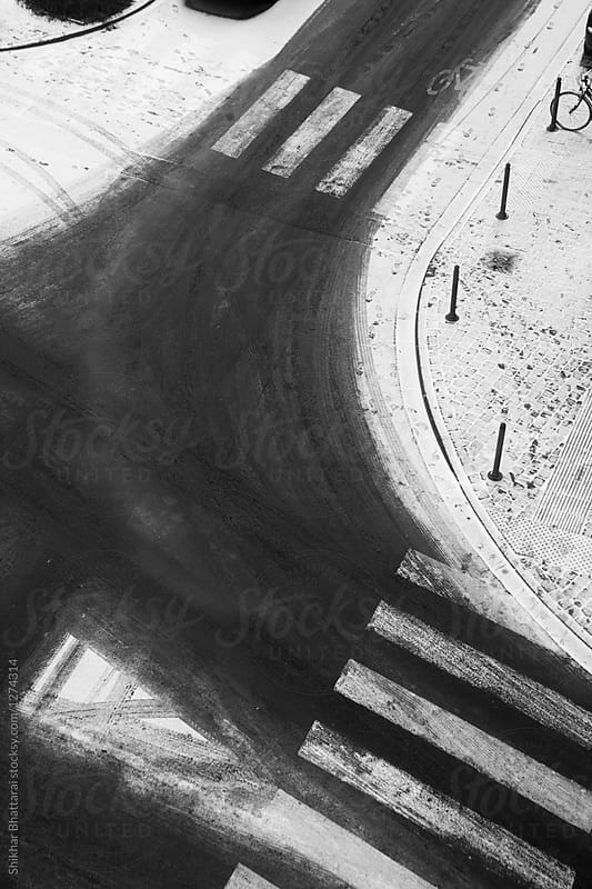Aerial view of a curve on a snowy empty street