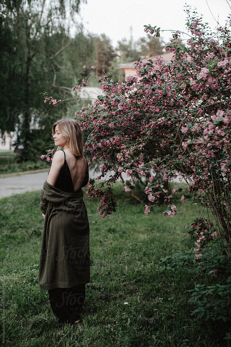 Woman in dress under blooming tree