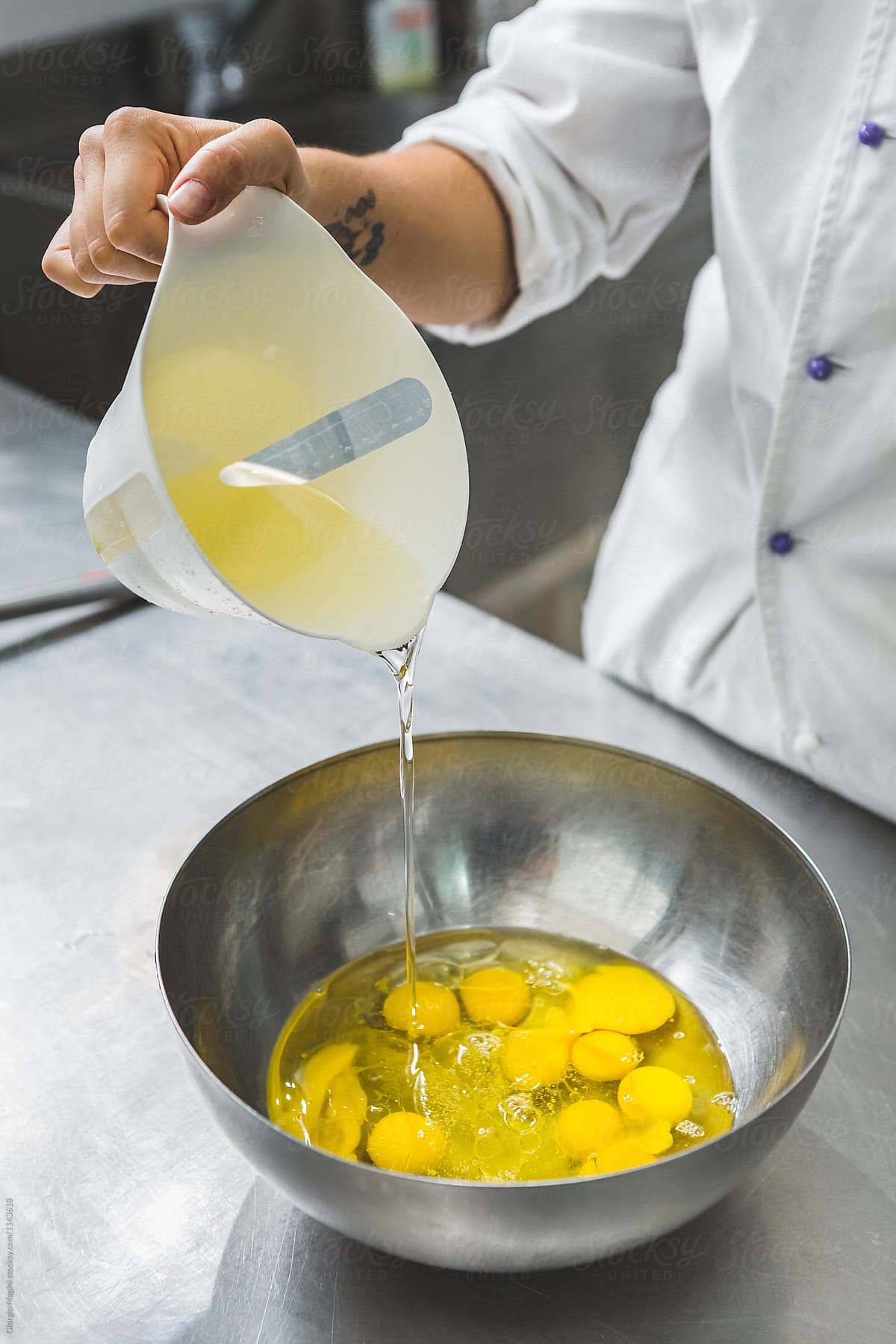 Pastry Chef Pouring Oil to a Bowl Full of Eggs