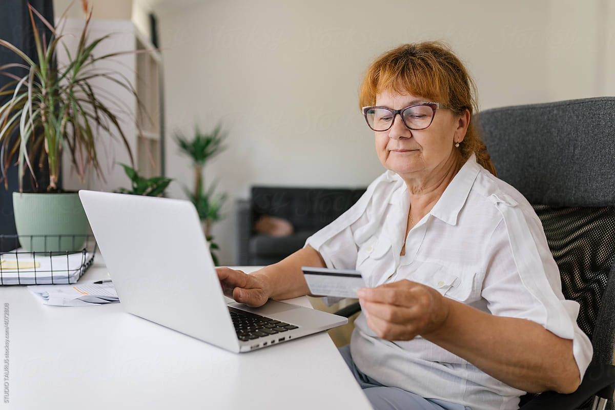 Senior woman using credit card for online payment