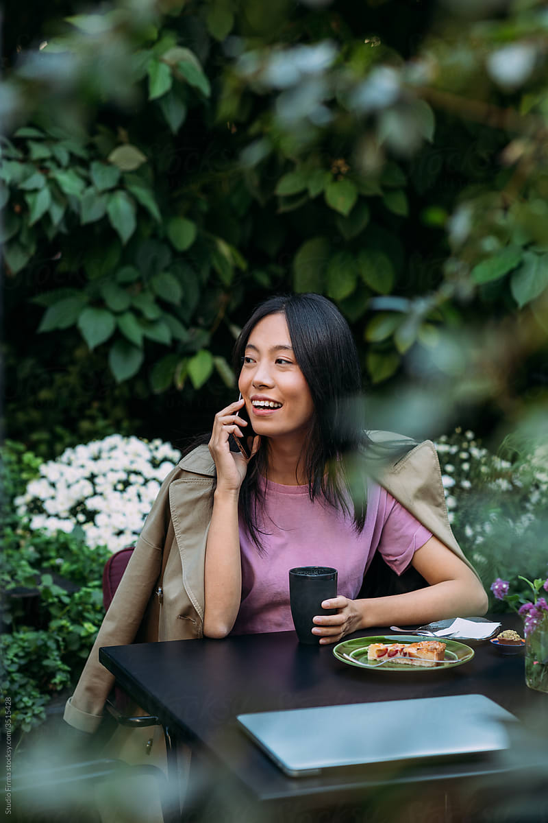 An Asian Woman Talking on the Phone