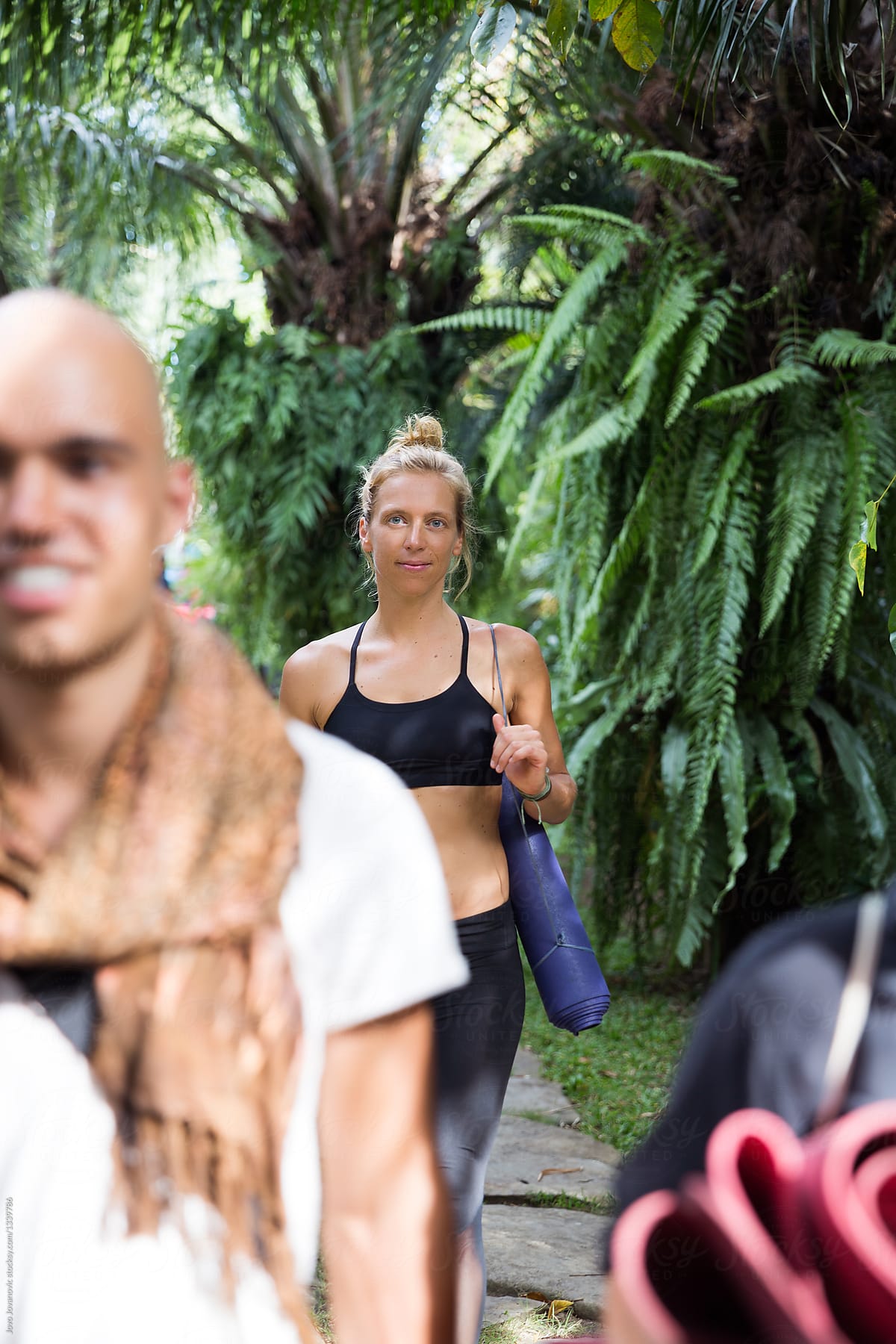 Two young people walking to a yoga practice