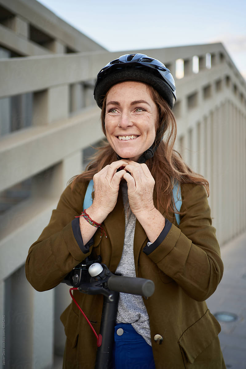 Positive woman leaning on e scooter