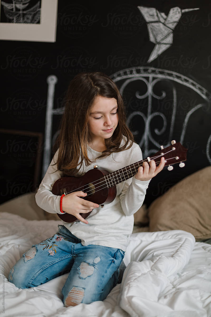 Girl playing on ukulele
