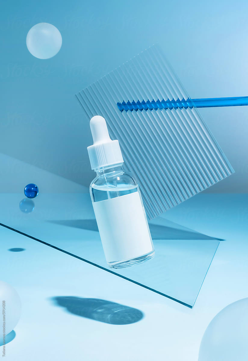 A bottle of cosmetics levitating on a blue background with spheres