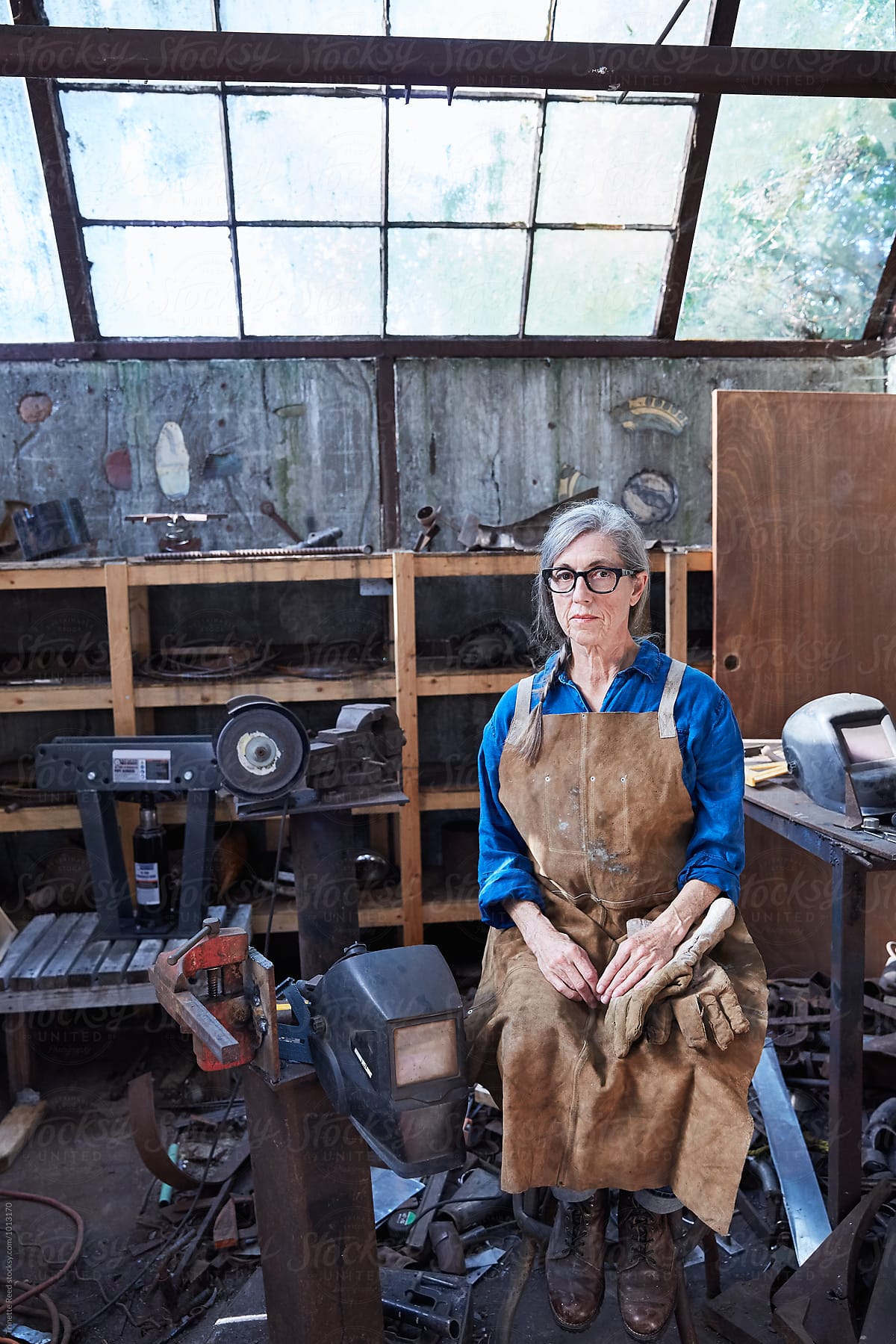 Portrait of senior woman inside her metal shop