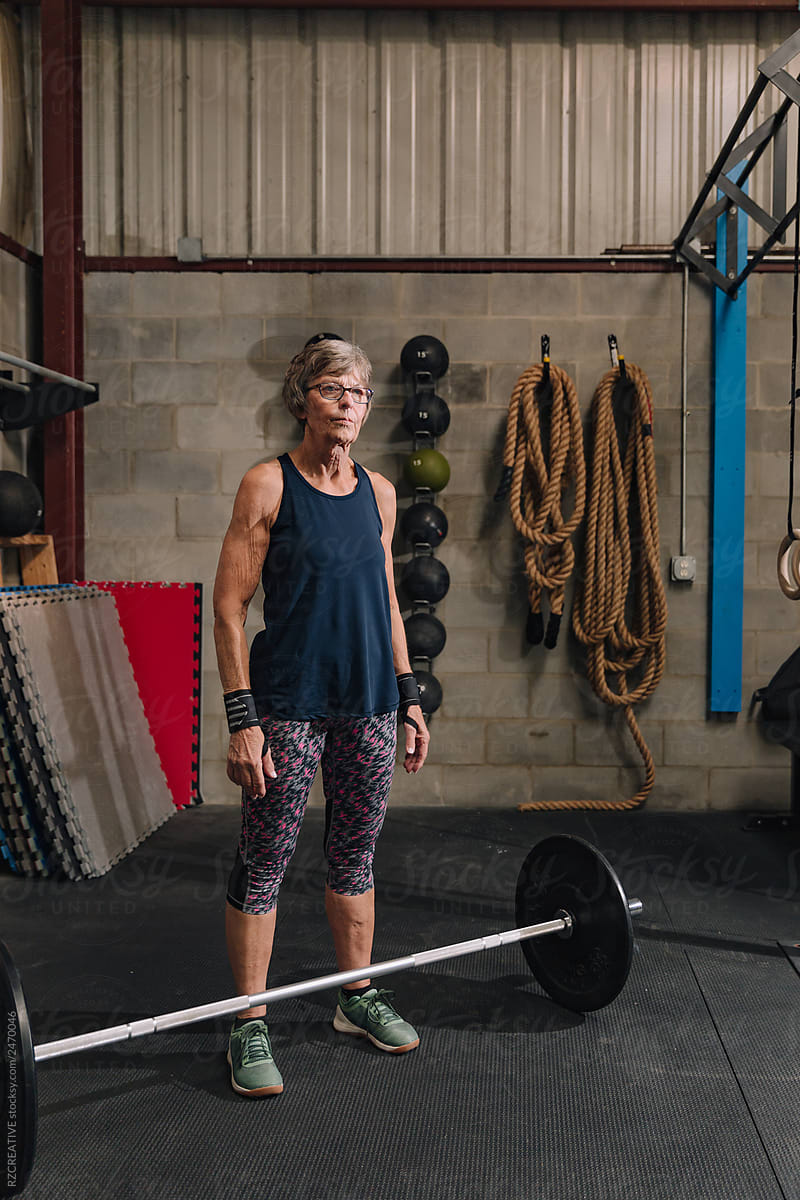 Senior woman lifting at gym